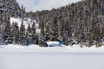 The shelter is covered in snow