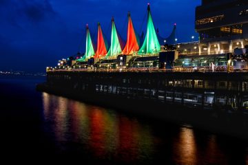 Sails at Canada Place lighted up in green and red, holiday colors